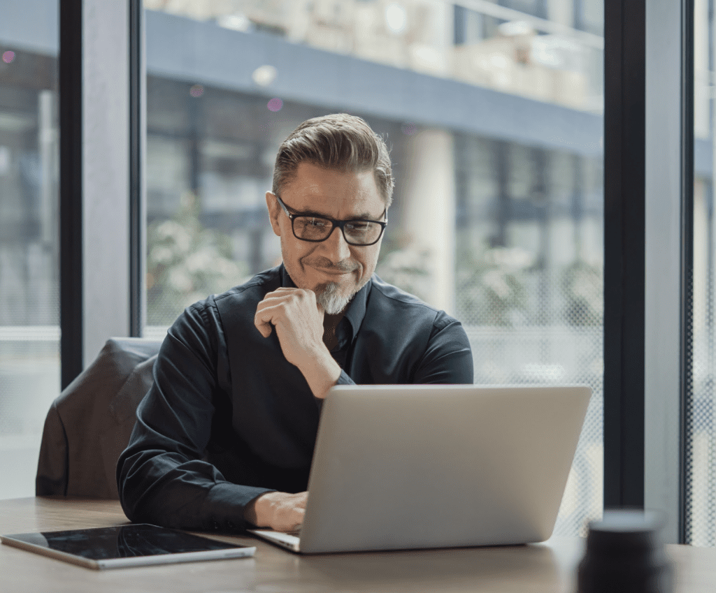 An employee sat at a desk working from a laptop.